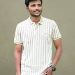 A man wearing a tan and white striped polo shirt and dark pants, shown from both the front and back. The shirt has a solid tan collar and short sleeves with solid tan cuffs.