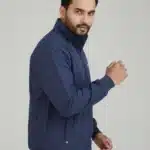 Male model wearing a Uton navy blue stand-collar jacket with a full zip. The jacket has small zip pockets on the side.