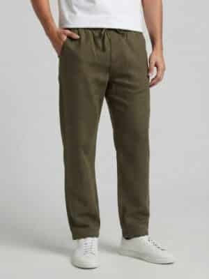 Loose fit comfortable olive green summer trousers for men, breathable beach pants, relaxed-fit eco-friendly linen bottoms, casual warm-weather loungewear.